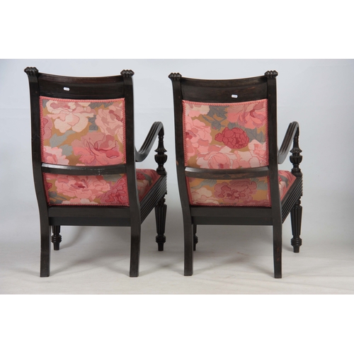 1328 - A PAIR OF 19TH CENTURY SOLID EBONY ANGLO INDIAN ARMCHAIRS with reeded shell carved back joined by sh... 