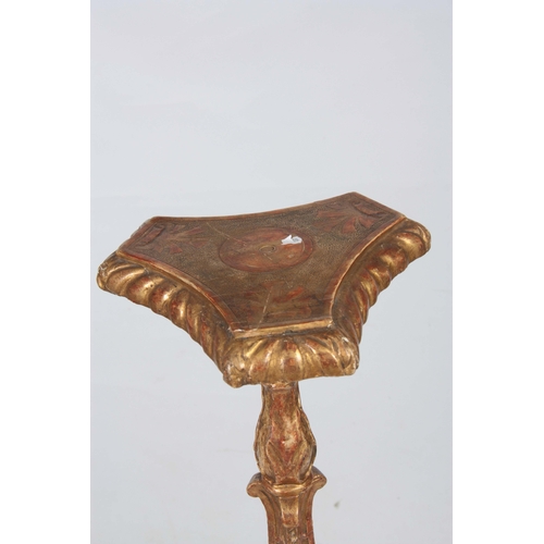 1330 - A GEORGE II CARVED GILT GESSO TORCHERE IN THE MANER OF JAMES MOORE having a gadroon edged top above ... 