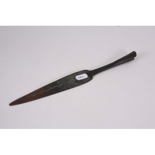 306 - AN EARLY ROMAN / MEDIEVAL BRONZE SPEARHEAD with punched decoration 30.5cm overall.