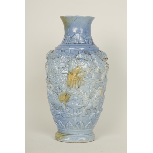 100 - A 19TH CENTURY PALE BLUE GLAZED RELIEF MOULDED CHINESE PORCELAIN VASE decorated with dogs of fo amid... 