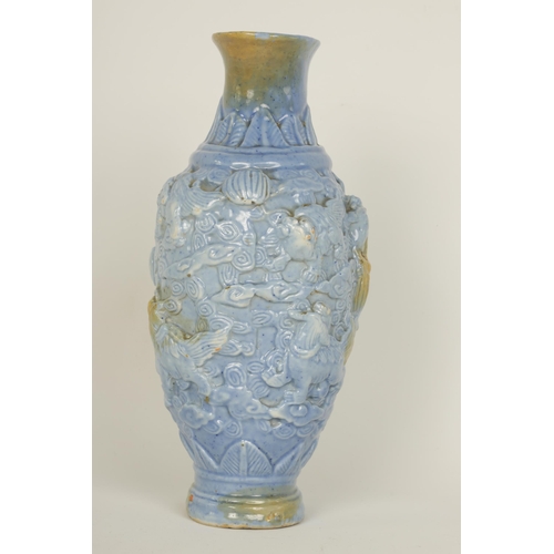 100 - A 19TH CENTURY PALE BLUE GLAZED RELIEF MOULDED CHINESE PORCELAIN VASE decorated with dogs of fo amid... 