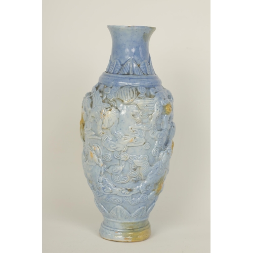 100 - A 19TH CENTURY PALE BLUE GLAZED RELIEF MOULDED CHINESE PORCELAIN VASE decorated with dogs of fo amid... 