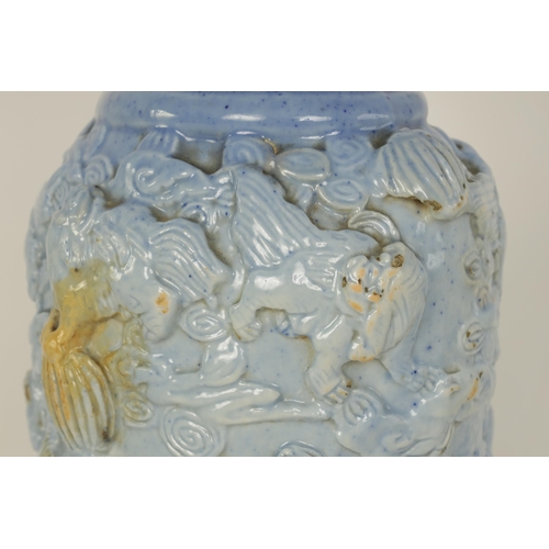 100 - A 19TH CENTURY PALE BLUE GLAZED RELIEF MOULDED CHINESE PORCELAIN VASE decorated with dogs of fo amid... 