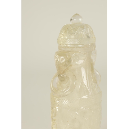 102 - A CHINESE CARVED ROCK CRYSTAL SNUFF BOTTLE AND COVER of flattened ovoid form with elephants head and... 