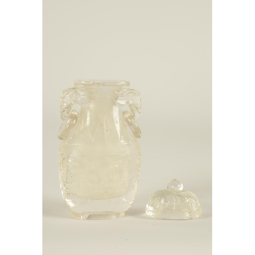 102 - A CHINESE CARVED ROCK CRYSTAL SNUFF BOTTLE AND COVER of flattened ovoid form with elephants head and... 