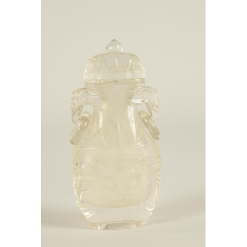 102 - A CHINESE CARVED ROCK CRYSTAL SNUFF BOTTLE AND COVER of flattened ovoid form with elephants head and... 