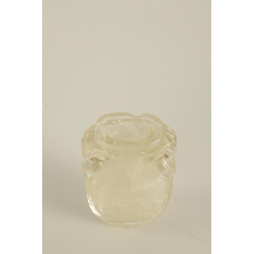 102 - A CHINESE CARVED ROCK CRYSTAL SNUFF BOTTLE AND COVER of flattened ovoid form with elephants head and... 