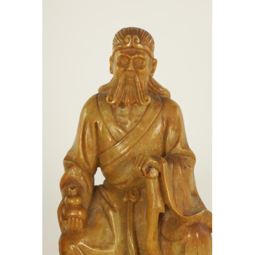 106 - A COLLECTION OF FOUR CHINESE SOAPSTONE CARVINGS modelled as seated immortals raised on pierced carve... 