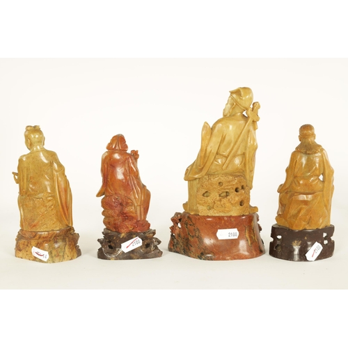 106 - A COLLECTION OF FOUR CHINESE SOAPSTONE CARVINGS modelled as seated immortals raised on pierced carve... 