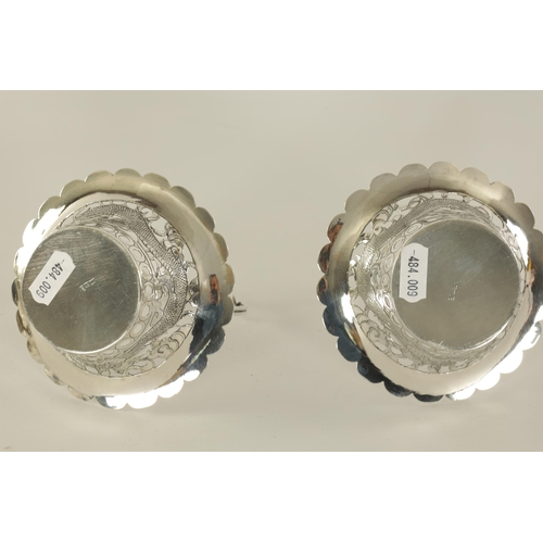 120 - A PAIR OF CHINESE SILVER SWEETMEAT BASKETS with double entwined loop handles on periced engraved bod... 