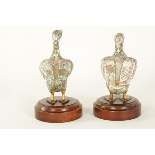 121 - A PAIR OF LATE 19TH CENTURY CHINESE MOTHER-OF-PEARL SCULPTURES MODELLED AS DUCKS with ivory beaks an... 