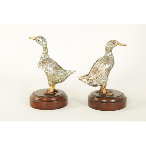 121 - A PAIR OF LATE 19TH CENTURY CHINESE MOTHER-OF-PEARL SCULPTURES MODELLED AS DUCKS with ivory beaks an... 