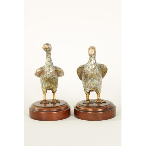 121 - A PAIR OF LATE 19TH CENTURY CHINESE MOTHER-OF-PEARL SCULPTURES MODELLED AS DUCKS with ivory beaks an... 