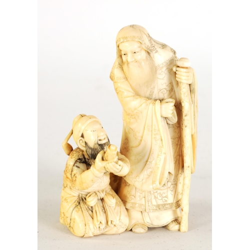 129 - AN EARLY 19TH CENTURY CARVED IVORY FIGURE GROUP depicting two elder scholars one stood with staff th... 