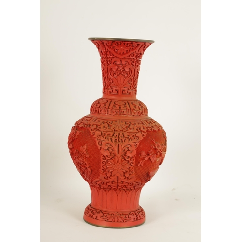 134 - AN EARLY 20TH CENTURY CHINESE CINNABAR VASE intricately carved with birds amongst blossoming branche... 