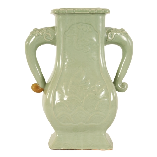 137 - A 19TH CENTURY CELADON GLAZED CHINESE VASE of shaped bulbous form with tusk side handles, panelled f... 