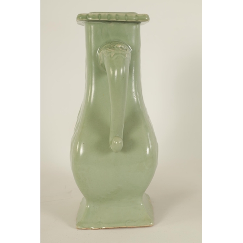 137 - A 19TH CENTURY CELADON GLAZED CHINESE VASE of shaped bulbous form with tusk side handles, panelled f... 