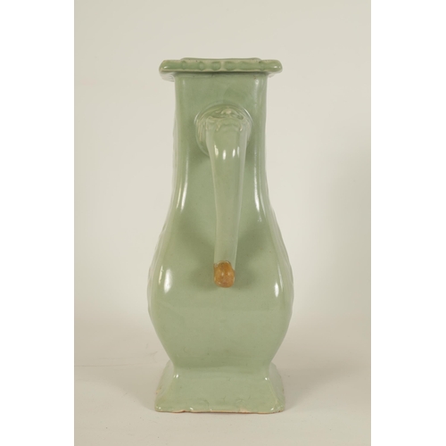 137 - A 19TH CENTURY CELADON GLAZED CHINESE VASE of shaped bulbous form with tusk side handles, panelled f... 