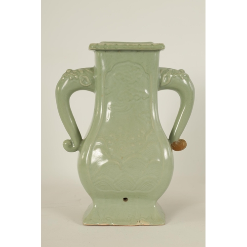 137 - A 19TH CENTURY CELADON GLAZED CHINESE VASE of shaped bulbous form with tusk side handles, panelled f... 