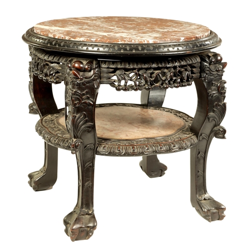 139 - A 19TH CENTURY CHINESE HARDWOOD JARDINIERE STAND with circular marble top above a carved pierced fri... 