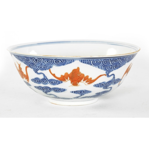 141 - A CHINESE GUANGXI PERIOD IRON-RED-DECORATED BLUE AND WHITE BAT BOWL decorated with gilt highlighted ... 