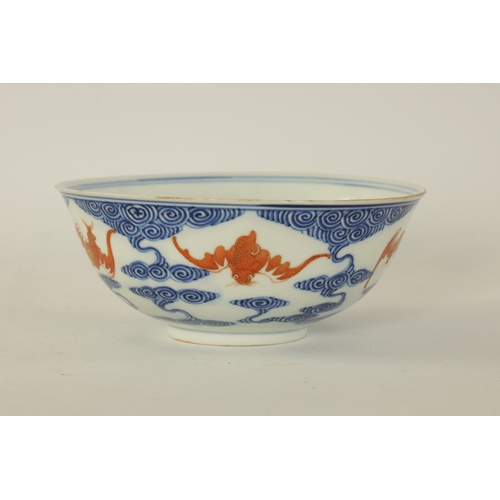 141 - A CHINESE GUANGXI PERIOD IRON-RED-DECORATED BLUE AND WHITE BAT BOWL decorated with gilt highlighted ... 