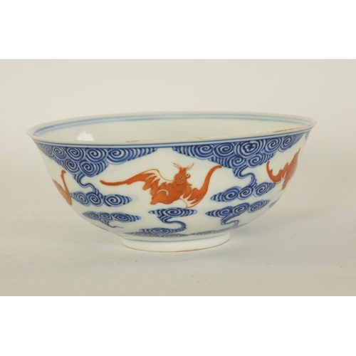 141 - A CHINESE GUANGXI PERIOD IRON-RED-DECORATED BLUE AND WHITE BAT BOWL decorated with gilt highlighted ... 