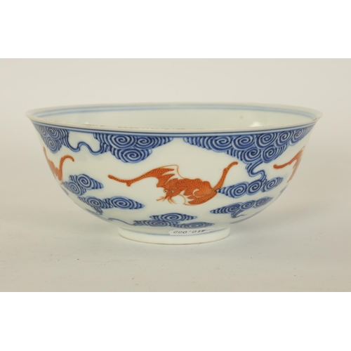 141 - A CHINESE GUANGXI PERIOD IRON-RED-DECORATED BLUE AND WHITE BAT BOWL decorated with gilt highlighted ... 