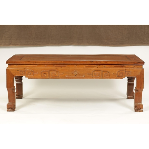 142 - A CHINESE HARDWOOD RECTANGULAR COFFEE TABLE with panelled top above a geometric carved base standing... 