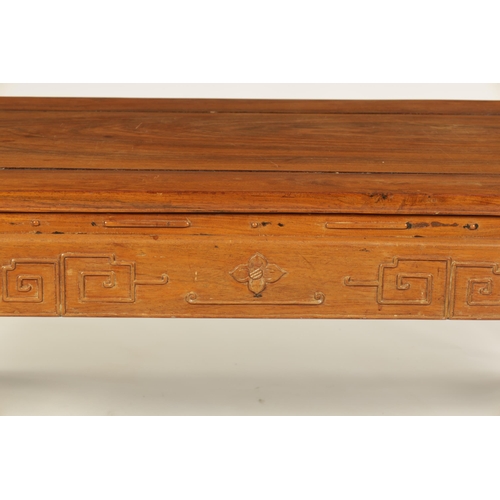 142 - A CHINESE HARDWOOD RECTANGULAR COFFEE TABLE with panelled top above a geometric carved base standing... 