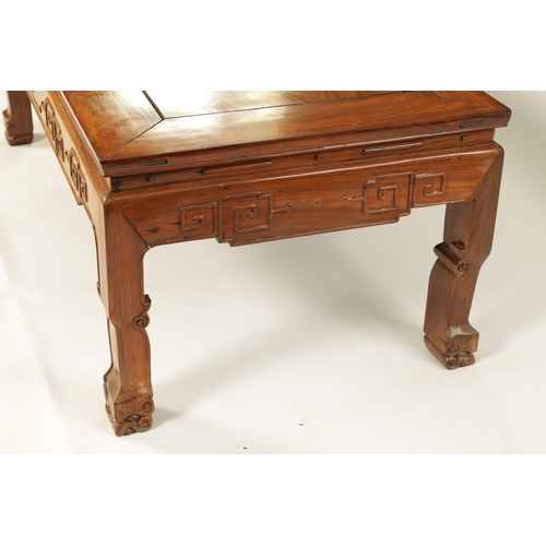 142 - A CHINESE HARDWOOD RECTANGULAR COFFEE TABLE with panelled top above a geometric carved base standing... 