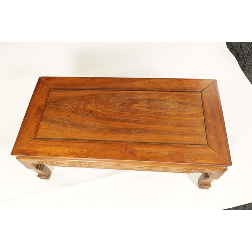 142 - A CHINESE HARDWOOD RECTANGULAR COFFEE TABLE with panelled top above a geometric carved base standing... 