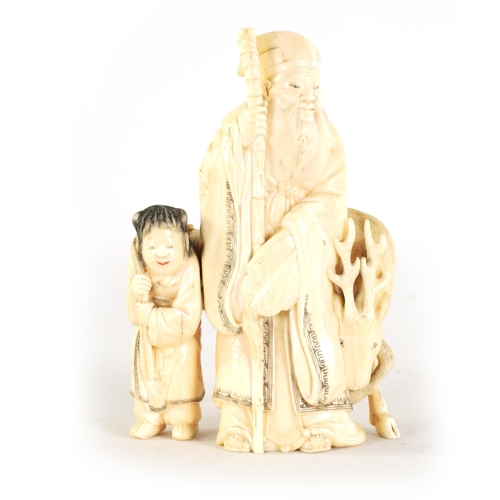 145 - A FINELY CARVED CHINESE IVORY SCULPTURE depicting a sage with a young child and a deer - signed to t... 