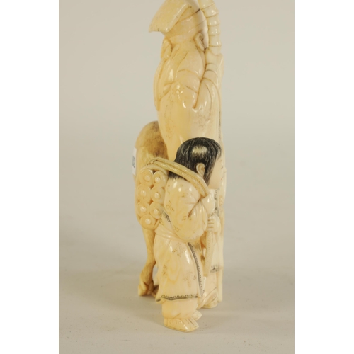 145 - A FINELY CARVED CHINESE IVORY SCULPTURE depicting a sage with a young child and a deer - signed to t... 