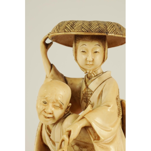 148 - A JAPANESE MEIJI PERIOD CARVED IVORY OKIMONO finely carved depiciting a lady and gentleman with dog ... 