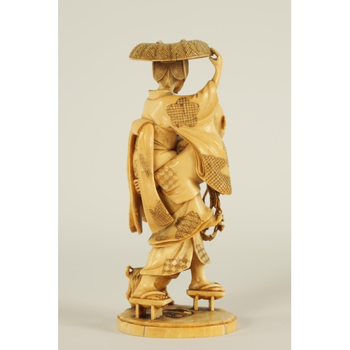 148 - A JAPANESE MEIJI PERIOD CARVED IVORY OKIMONO finely carved depiciting a lady and gentleman with dog ... 