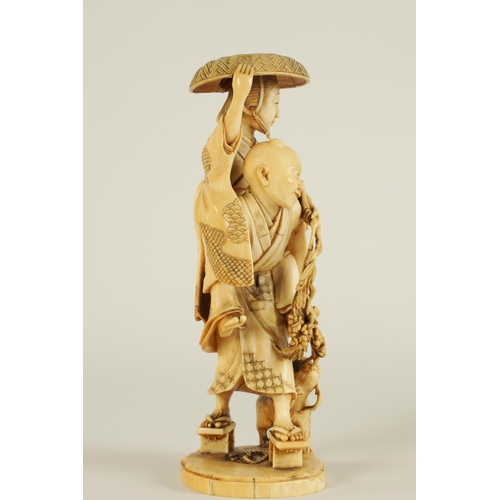 148 - A JAPANESE MEIJI PERIOD CARVED IVORY OKIMONO finely carved depiciting a lady and gentleman with dog ... 