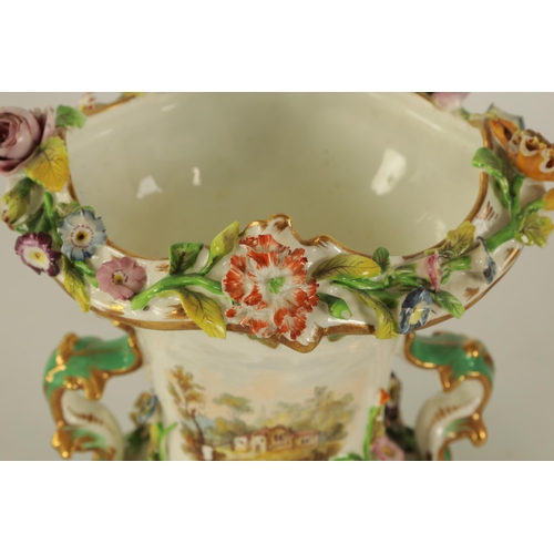 15 - A 19TH CENTURY FLORALLY ENCRUSTED LEAF-HANDLED PEDESTAL VASE with scalloped rim above a gilt embelli... 