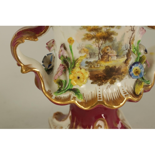 15 - A 19TH CENTURY FLORALLY ENCRUSTED LEAF-HANDLED PEDESTAL VASE with scalloped rim above a gilt embelli... 