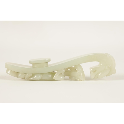 150 - A LARGE 18TH/19TH CENTURY CARVED WHITE JADE BELT HOOK the top carved in openwork and undercut with a... 