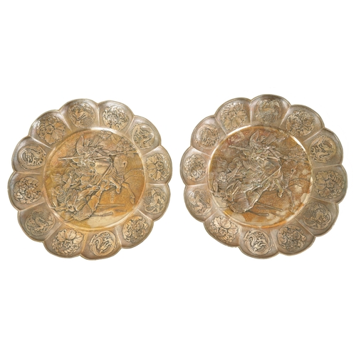 153 - A PAIR OF 19TH CENTURY SILVERED METAL CHINESE CIRCULAR HANGING PLAQUES the panelled petal-shaped bor... 