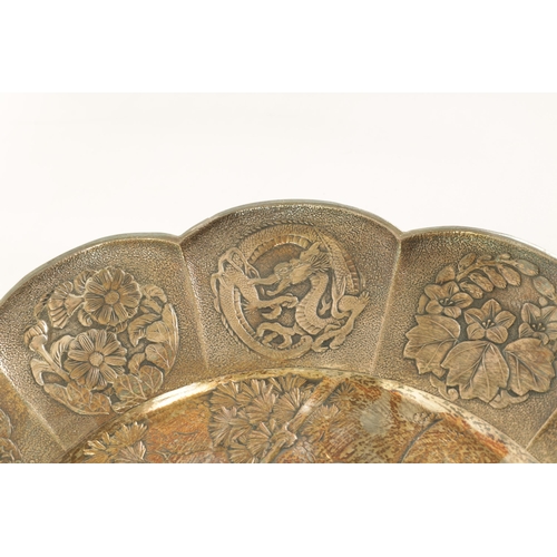 153 - A PAIR OF 19TH CENTURY SILVERED METAL CHINESE CIRCULAR HANGING PLAQUES the panelled petal-shaped bor... 