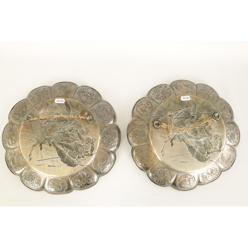 153 - A PAIR OF 19TH CENTURY SILVERED METAL CHINESE CIRCULAR HANGING PLAQUES the panelled petal-shaped bor... 