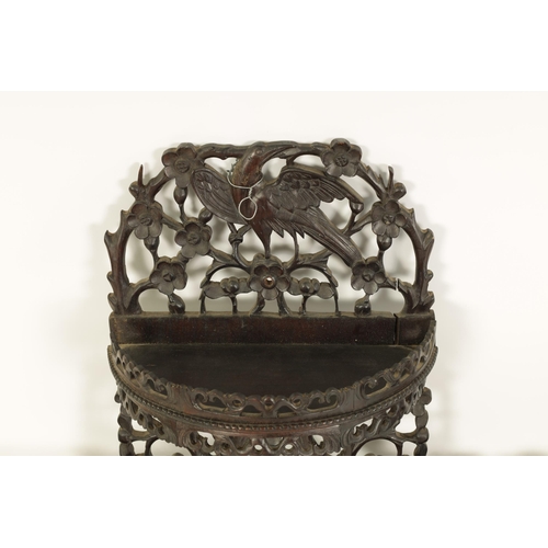 164 - A PAIR OF 19TH CENTURY CHINESE CARVED HARDWOOD HANGING SHELVES with pierced floral branchwork and bi... 