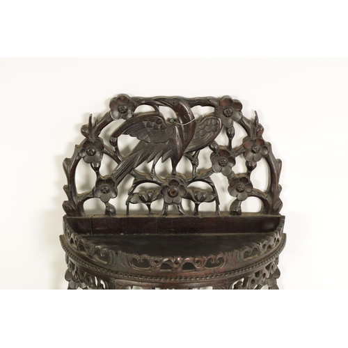 164 - A PAIR OF 19TH CENTURY CHINESE CARVED HARDWOOD HANGING SHELVES with pierced floral branchwork and bi... 