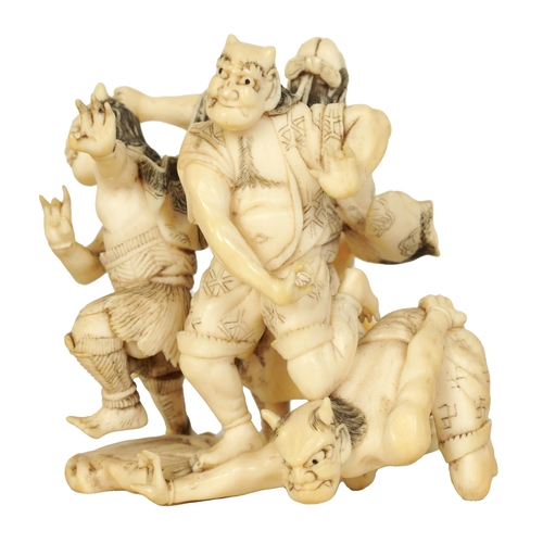 172 - A JAPANESE MEIJI PERIOD CARVED IVORY SCULPTURE depicting three guardians and a samurai. (6cm high )