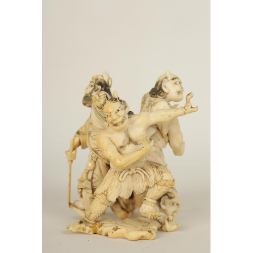 172 - A JAPANESE MEIJI PERIOD CARVED IVORY SCULPTURE depicting three guardians and a samurai. (6cm high )