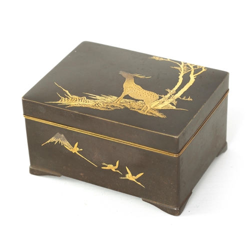 173 - A JAPANESE MEIJI PERIOD GILT METAL IRON WORK BOX decorated with a stag under trees to the lid, the s... 