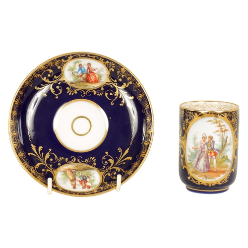 18 - A LATE 19TH CENTURY VIENNA STYLE SCROLLED GILT AND ROYAL BLUE CABINET CUP AND SAUCER the cylindrical... 