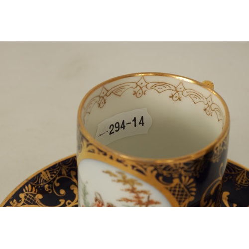 18 - A LATE 19TH CENTURY VIENNA STYLE SCROLLED GILT AND ROYAL BLUE CABINET CUP AND SAUCER the cylindrical... 